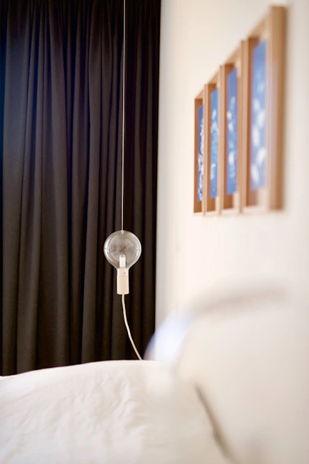 A minimalist, modern bedroom setting featuring subtle lighting and an elegant product display.