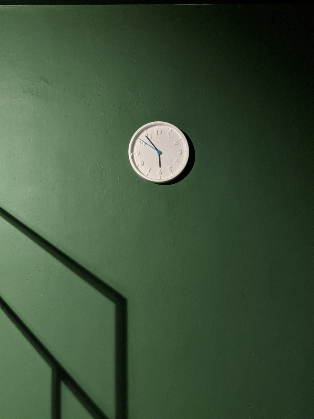analog wall clock displaying 5:54 time