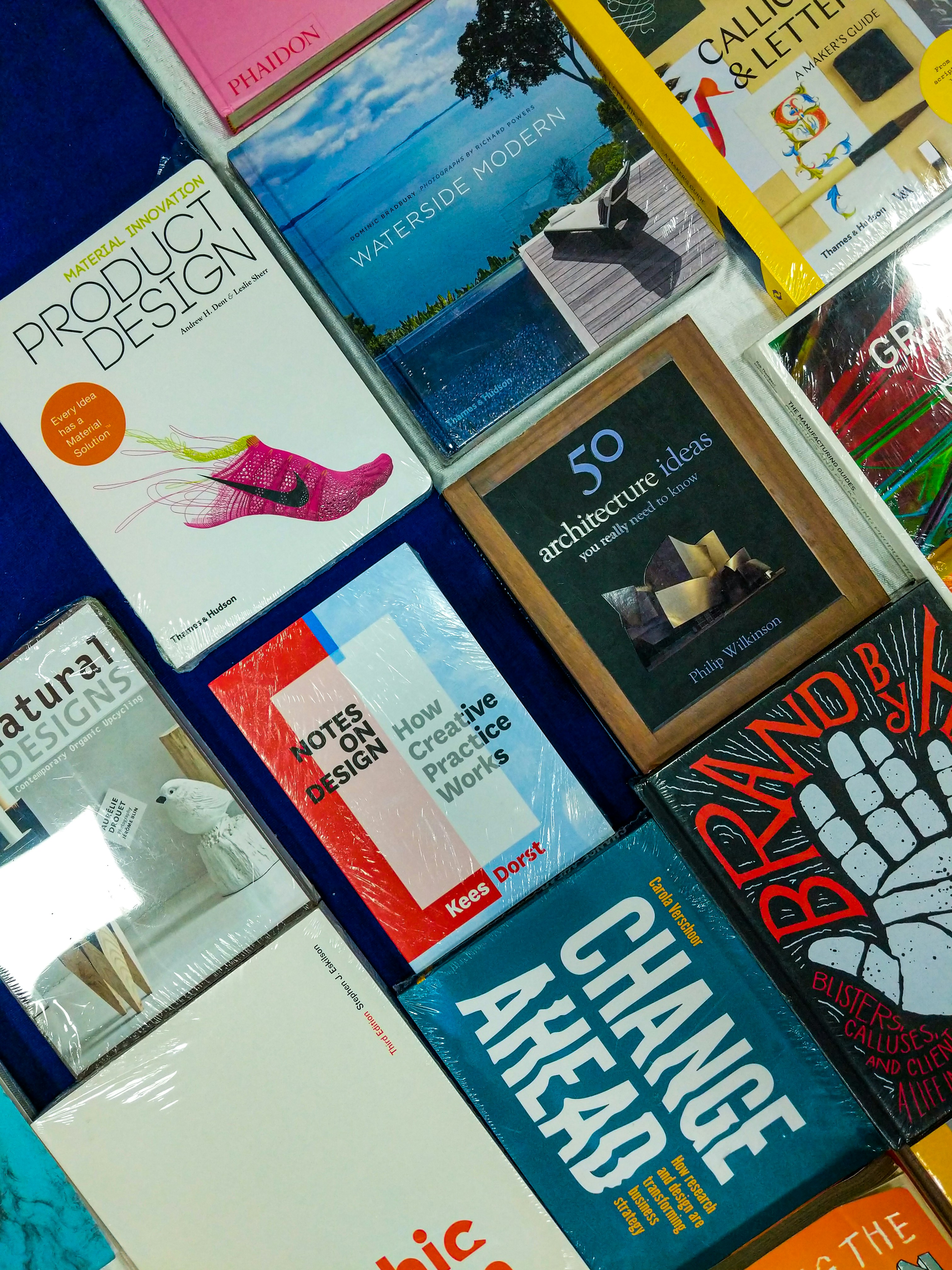 Stack of professionally designed books on a clean desk in bright natural light