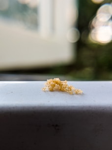 DAP fertilizer crystals glistening under natural light on a rustic table.