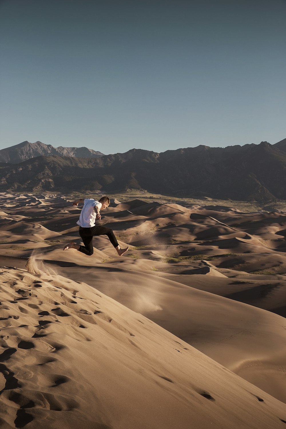 man jumping on desert