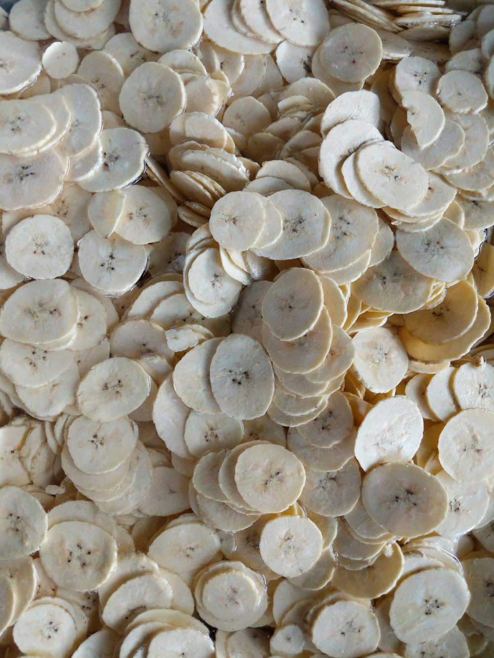 a pile of sliced bananas sitting on top of a table