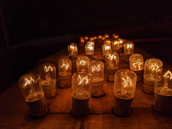 A bright assortment of LED bulbs displayed on a wooden table with warm lighting.