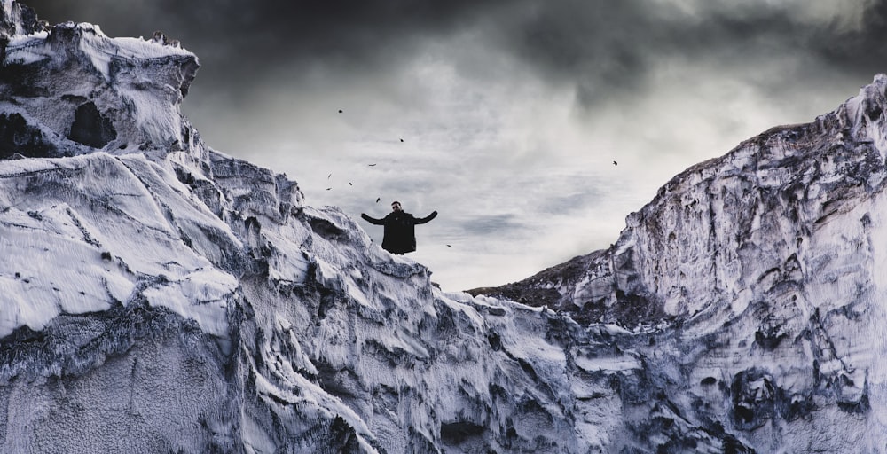 man standing on cliff during daytime