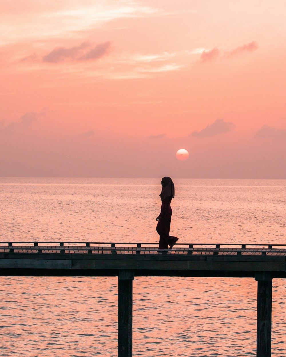 silhouette photography of woman on bridge