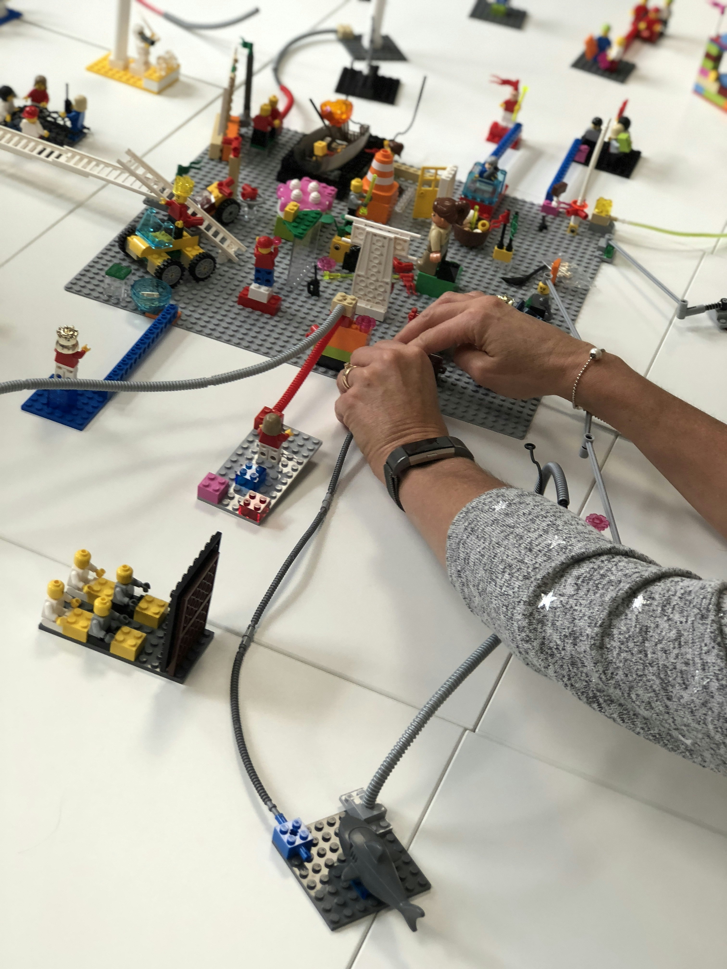 A creative LEGO game setup with bricks and minifigures arranged for play.