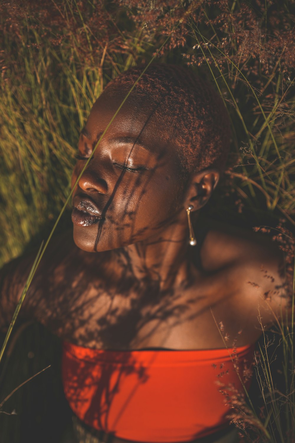 selective focus photography of woman lying down on green grass