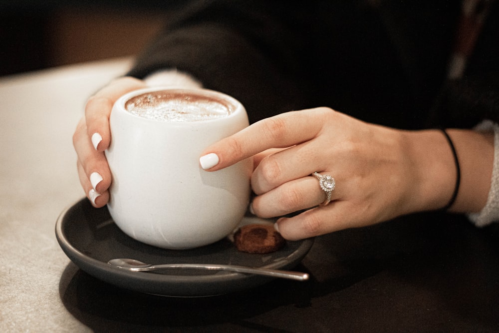 person holding cup of coffee