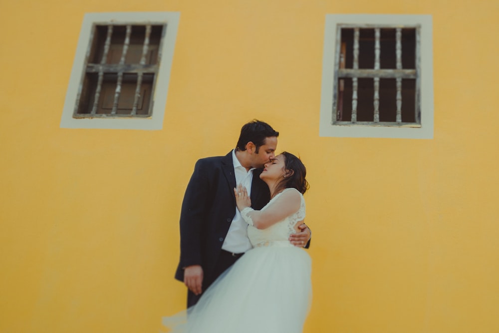 man kissing bride on forehead