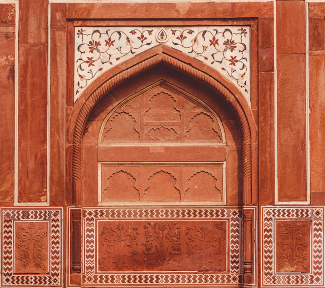 Close-up photo of brown and white floral building door