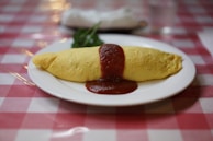 A beautifully plated omelette with herbs and vegetables.