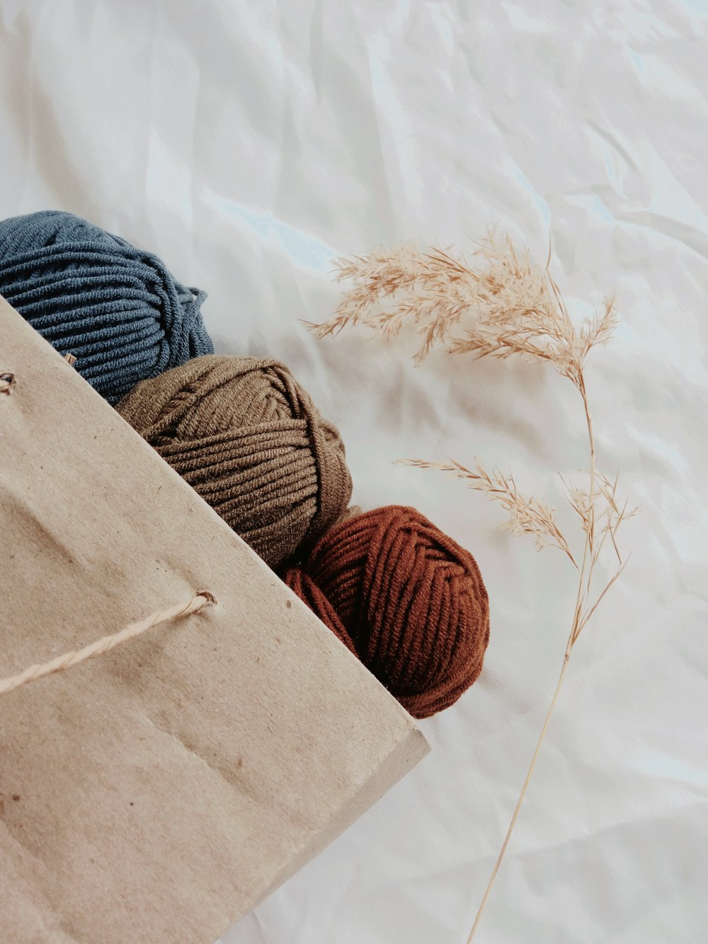 blue, brown, and orange yarn threads