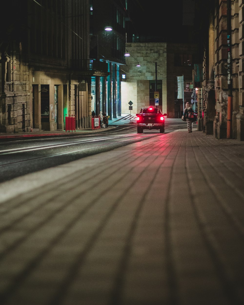 black vehicle on road at night