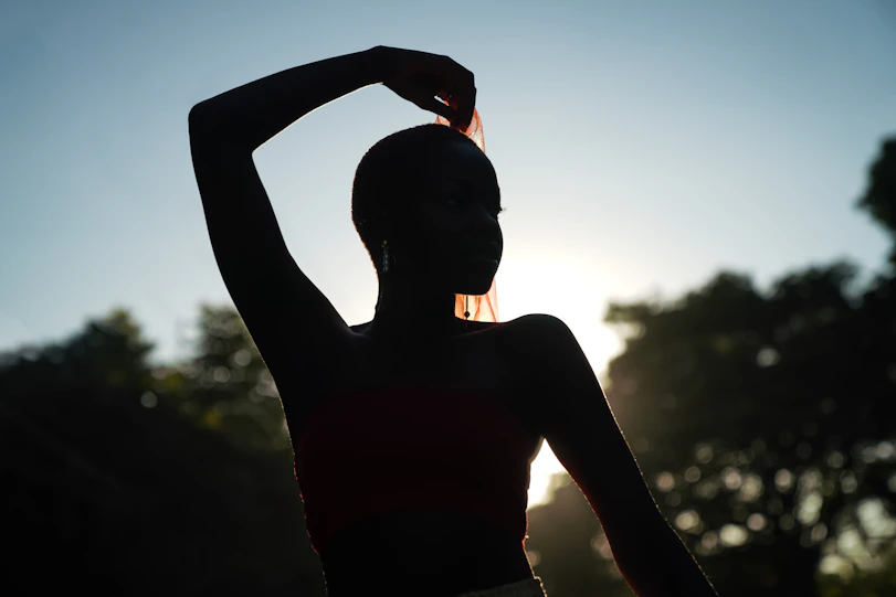 silhouette of woman during daytime. warrior pose