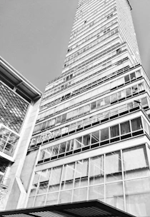 Black and white sketch of a sleek office building in the city center.