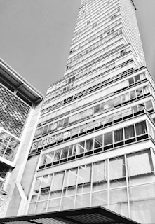 Black and white sketch of a sleek office building in the city center.