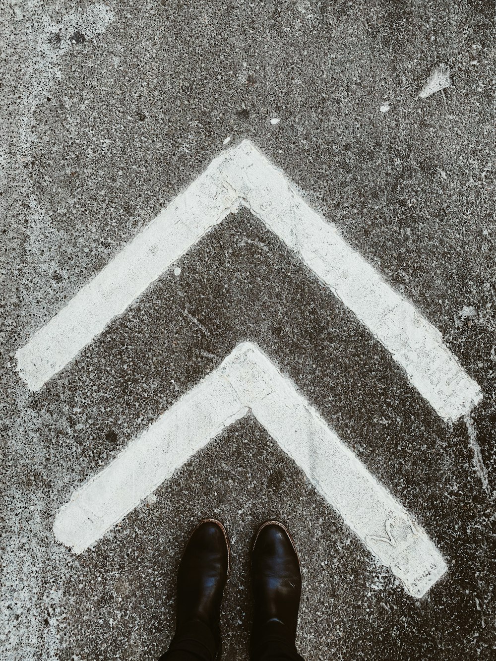a person standing in front of a white arrow