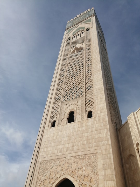 gray concrete tower during daytime in Hassan II Mosque Morocco