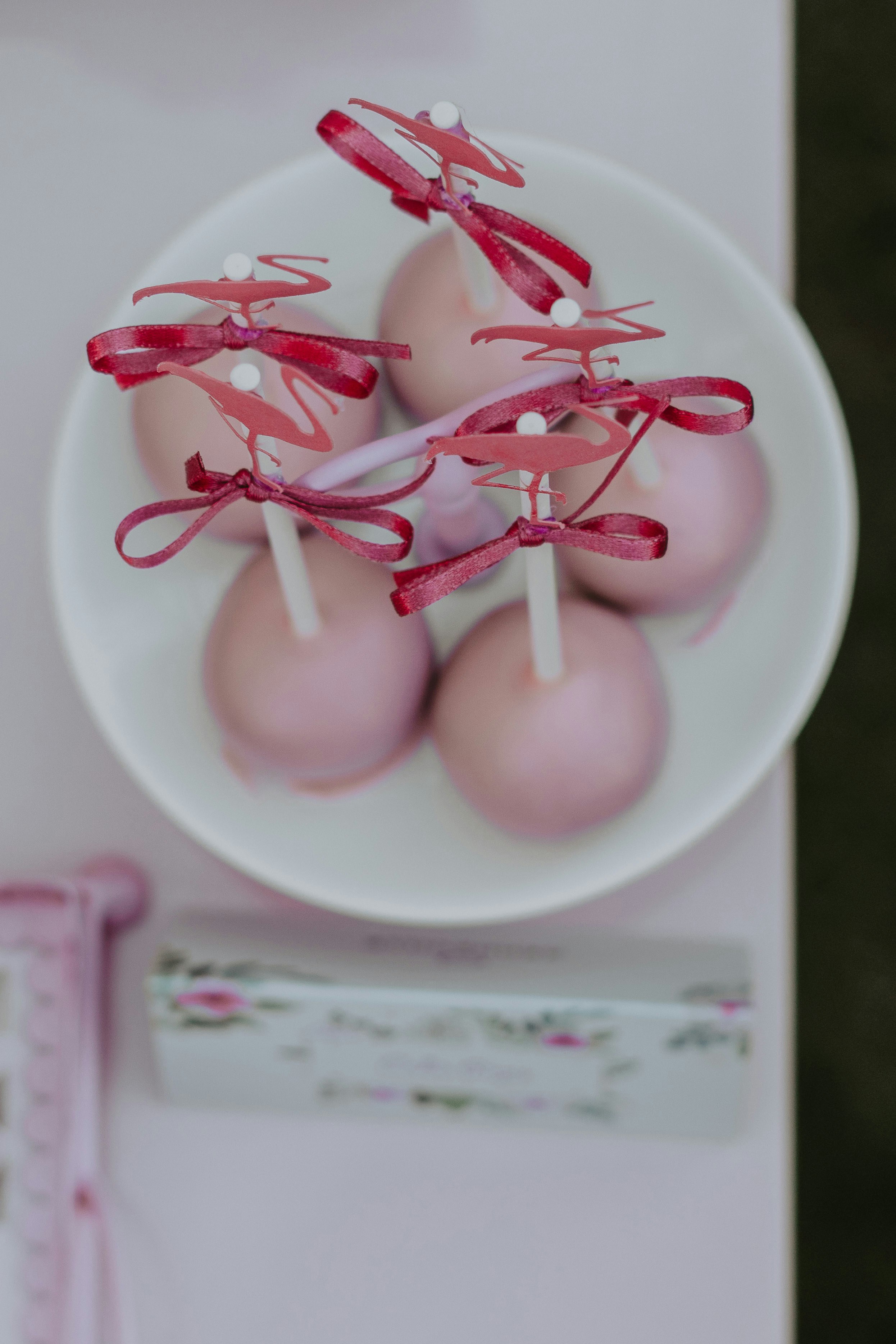 selective focus photography of pastry with stick on whit bowl