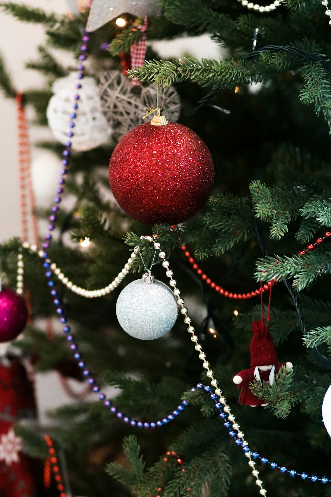 assorted-color baubles on christmas trees