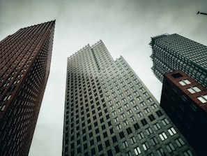 a couple of tall buildings sitting next to each other