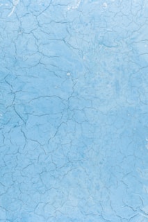 a blue surface with cracks and cracks in it