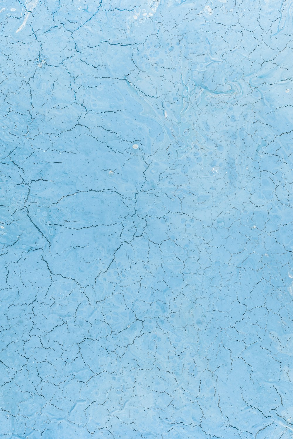a blue surface with cracks and cracks in it