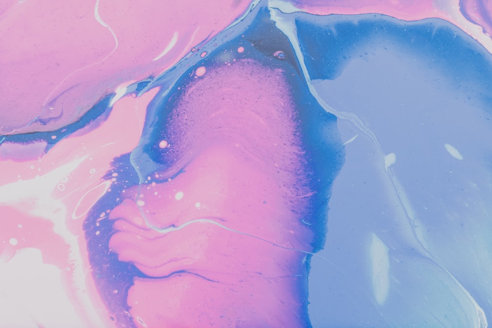 a close up of a pink and blue liquid