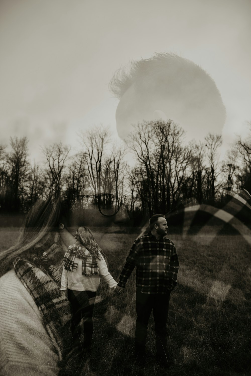 man and woman standing on grass field