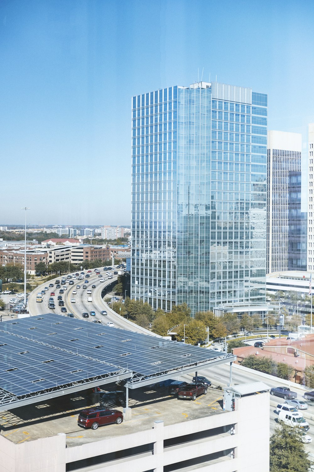 aerial photography of city with high-rise buildings and different vehicles on road during daytime