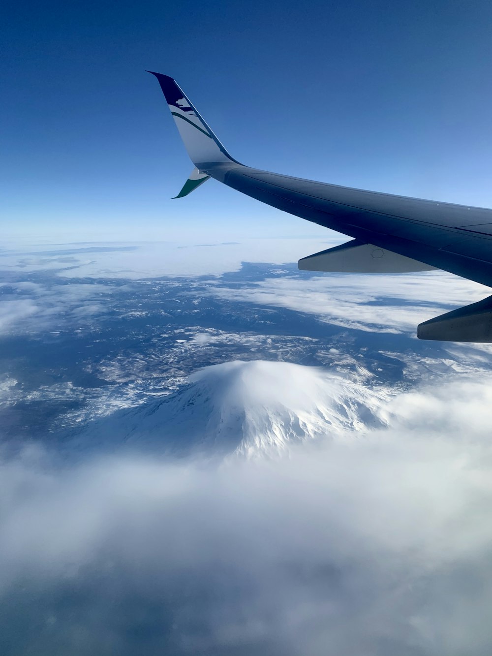 white and blue tail of airplane during daytime