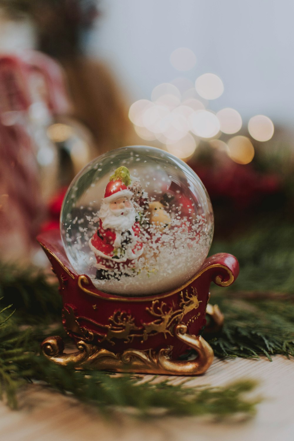 Santa Claus riding on sleigh snow globe