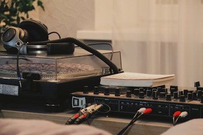 A close-up of a DJ mixing tracks with headphones on.