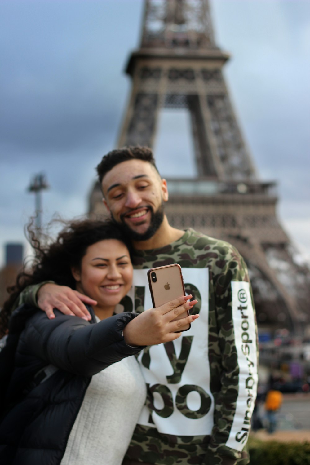 man and woman taking picture near Eiffel Tower in Paris