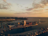 Aerial view of an integrated energy grid system supporting port infrastructure at sunset.