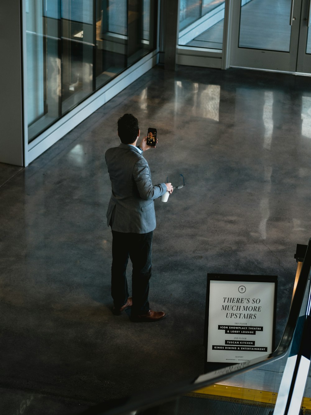 man holding smartphone inside building