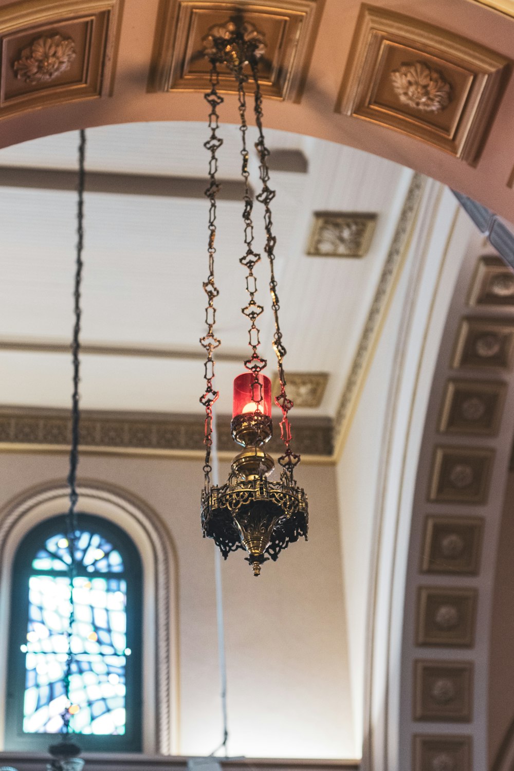 brass-colored pendant lamp inside building