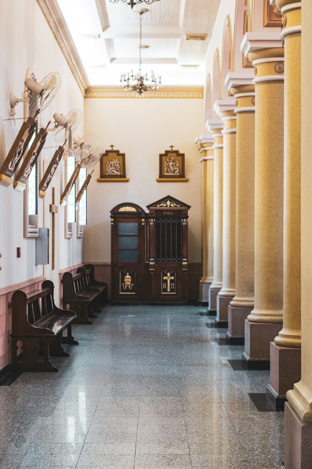 Benches Near Pillars And Cabinet Inside Building Photo