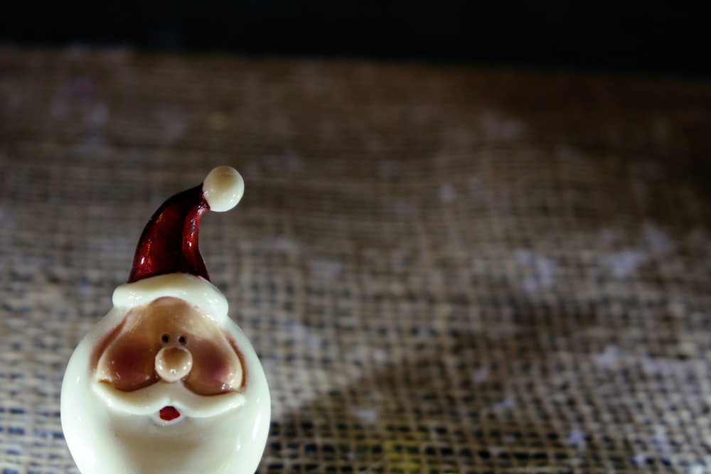 Santa Claus head figurine on brown textile