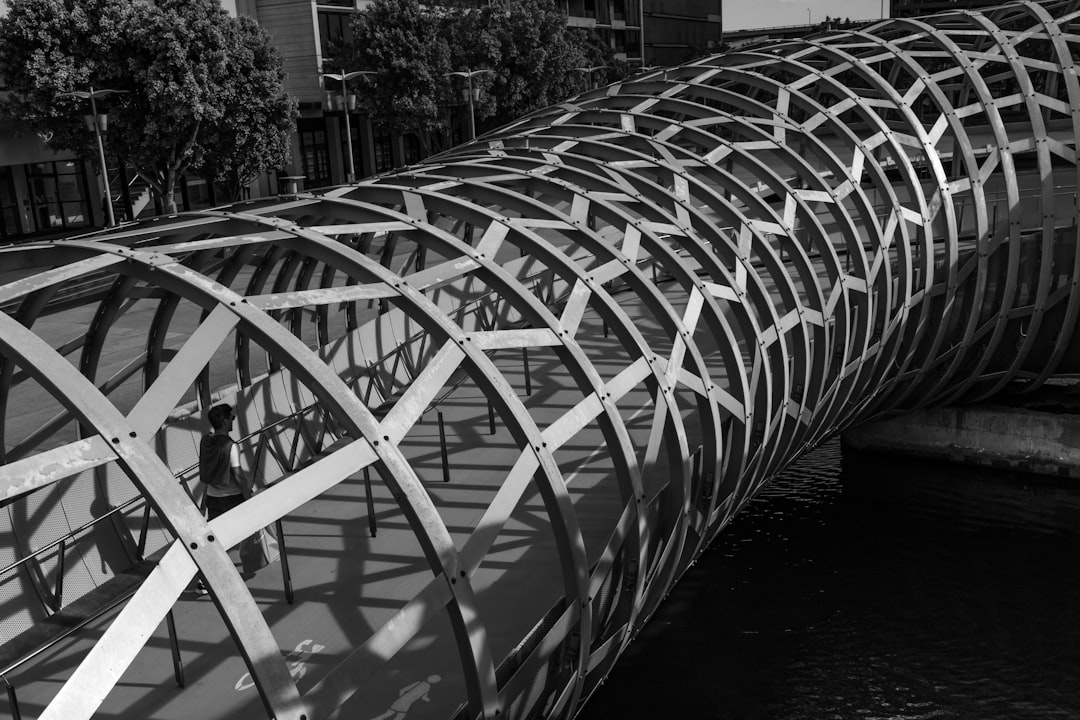 person walking in cutout bridge tunnel