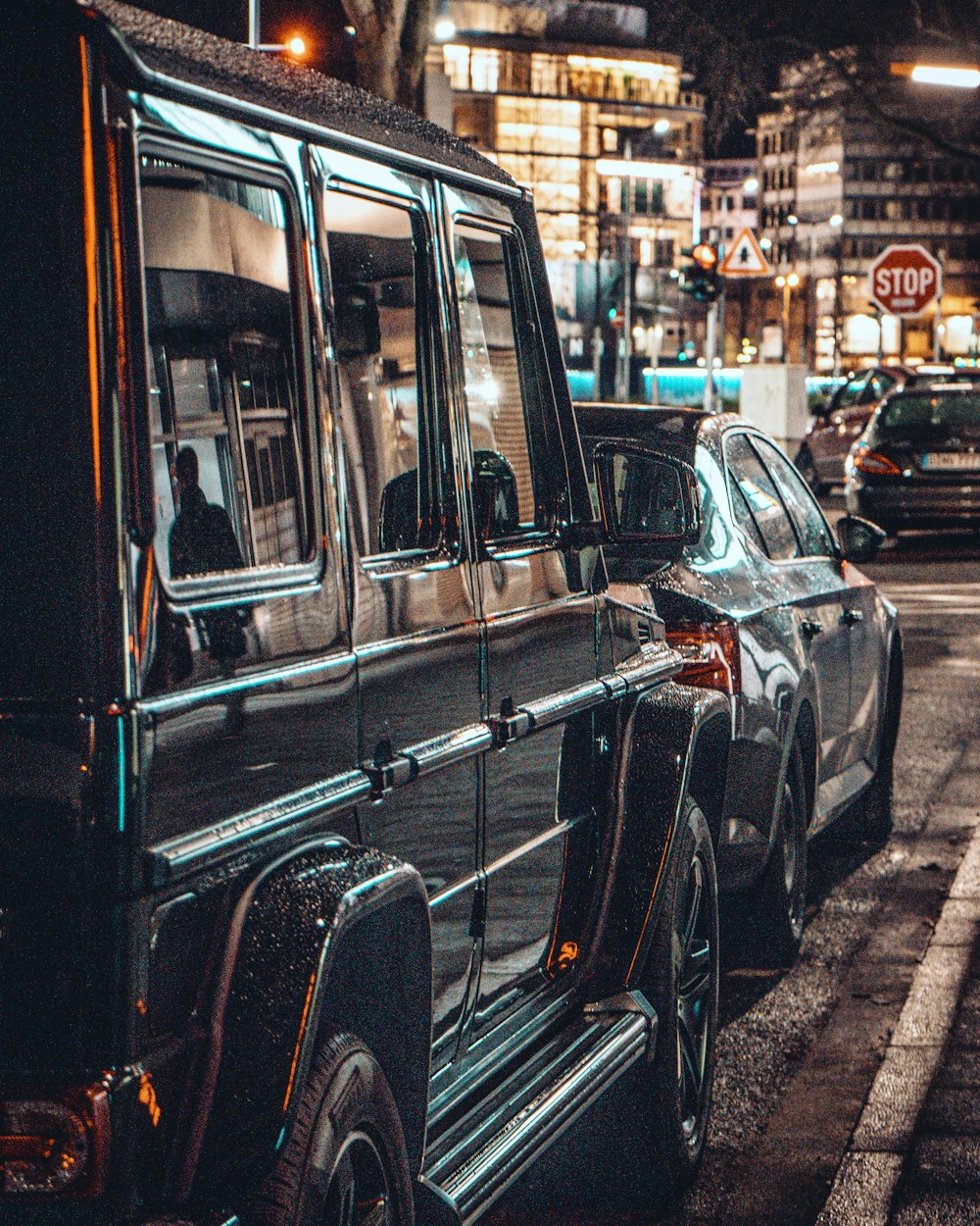 vehicles parked beside curb at night