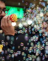 Bubble machine creating a whimsical atmosphere with floating bubbles at a festive gathering.