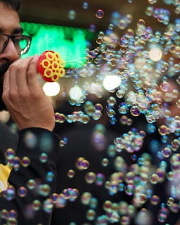 Bubble machine creating a whimsical atmosphere with floating bubbles at a festive gathering.