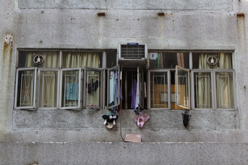 gray building showing open windows