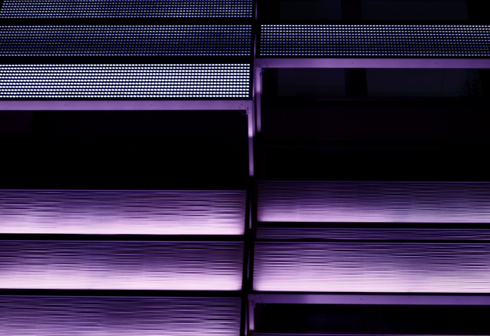 a close up of a building with purple lights