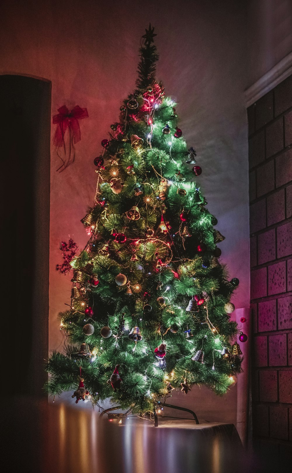 green Christmas tree with decorations and lighted string lights