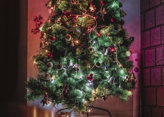 green Christmas tree with decorations and lighted string lights