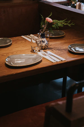 round gray ceramic plate near knife and fork on a table