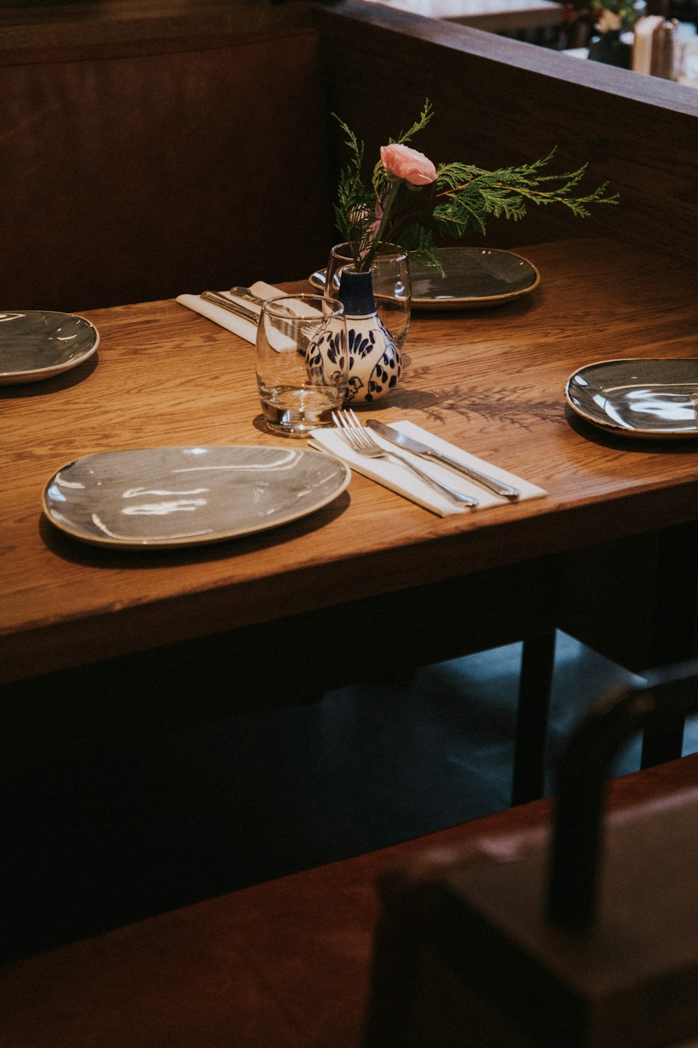 round gray ceramic plate near knife and fork on a table