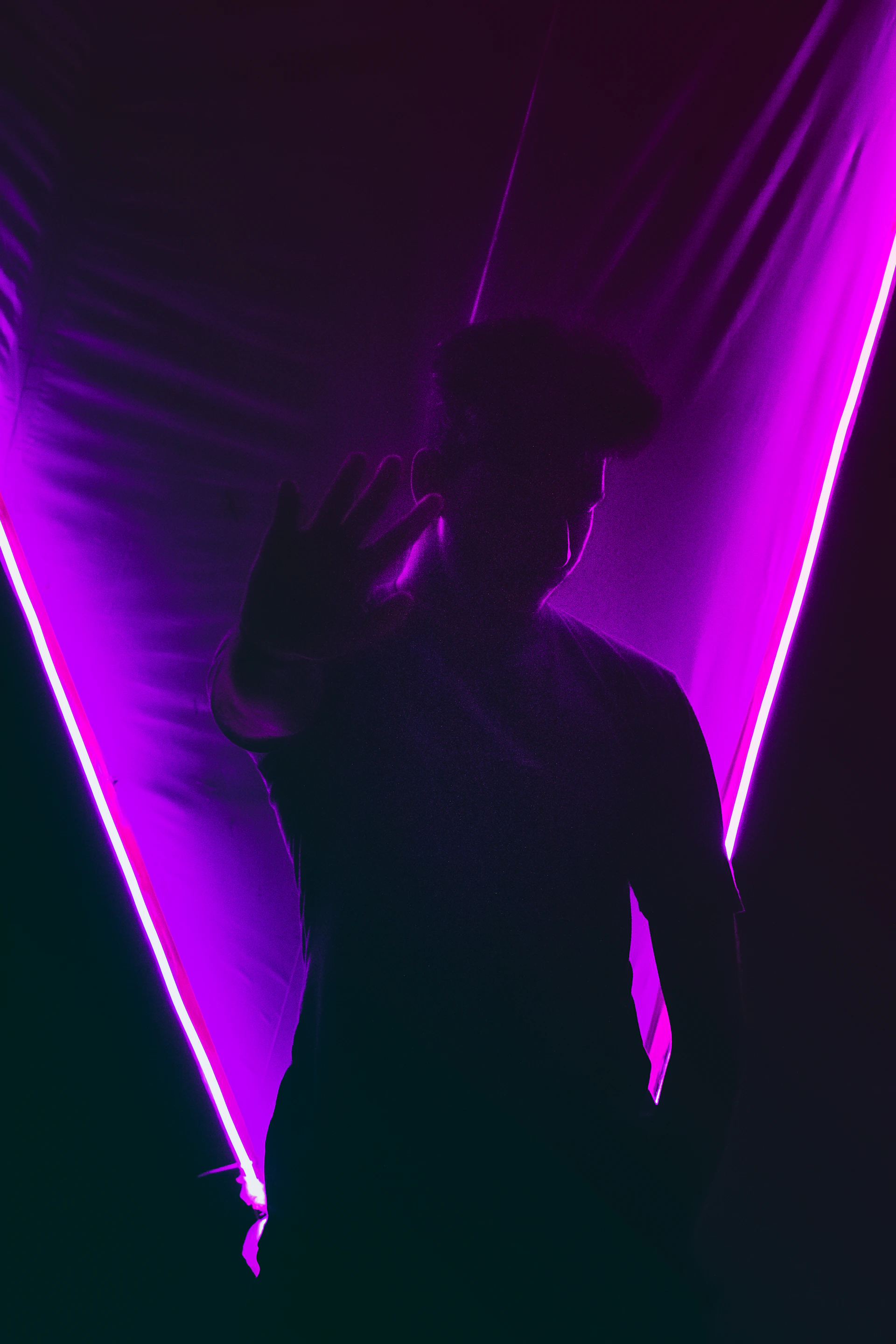 man standing near the purple textile